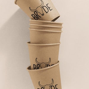 May include: Stack of six brown paper cups with a black bull skull and the word "BRIDE" printed on each cup.
