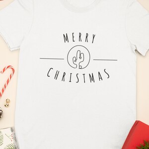 May include: White t-shirt with a black graphic that says "Merry Christmas" with a cactus illustration in a circle.