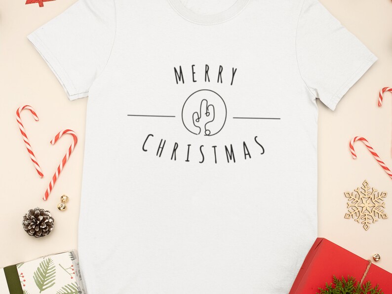 May include: White t-shirt with a black graphic that says "Merry Christmas" with a cactus illustration in a circle.