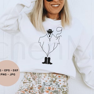 May include: A white sweatshirt with a black and white illustration of a ghost wearing a cowboy hat and boots. The text "SVG - EPS - DXF - PNG - JPG" is on a pink circle in the lower left corner of the image.
