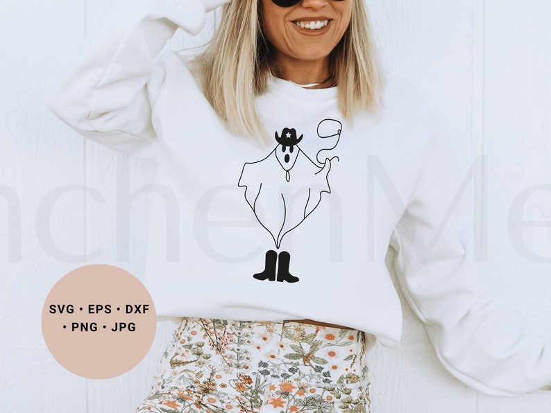 May include: A white sweatshirt with a black and white illustration of a ghost wearing a cowboy hat and boots. The text "SVG - EPS - DXF - PNG - JPG" is on a pink circle in the lower left corner of the image.