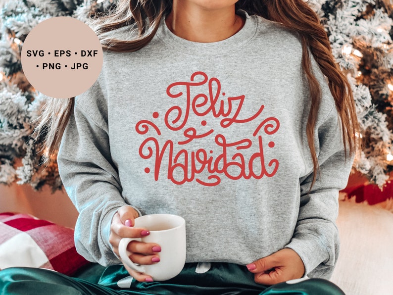 May include: A gray sweatshirt with the text "Feliz Navidad" in red cursive lettering.