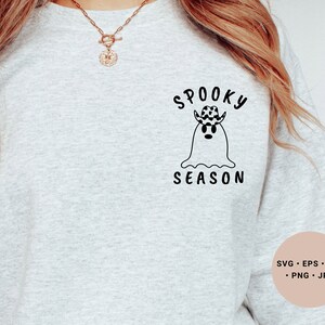 May include: A gray sweatshirt with a black and white graphic of a ghost wearing a cowboy hat with the text "Spooky Season".