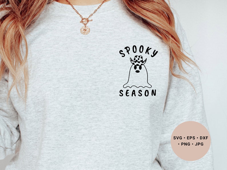 May include: A gray sweatshirt with a black and white graphic of a ghost wearing a cowboy hat with the text "Spooky Season".