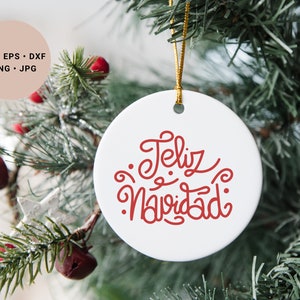 May include: White ceramic Christmas ornament with red lettering that says "Feliz Navidad".