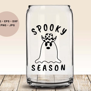 May include: A clear glass can with a black and white design of a ghost wearing a cowboy hat. The text "Spooky Season" is printed below the ghost.