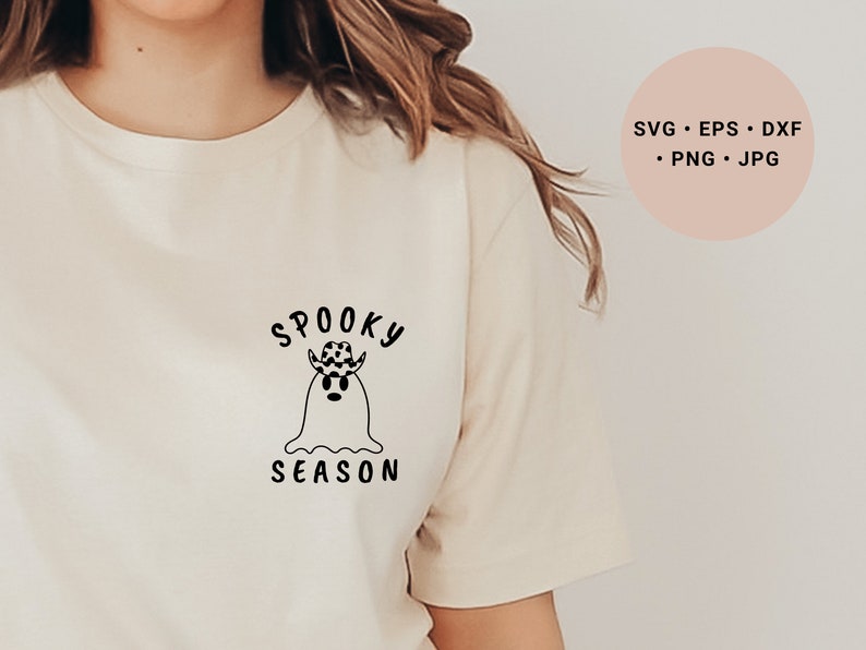 May include: A white t-shirt with a black graphic of a ghost wearing a cowboy hat and the text "Spooky Season".