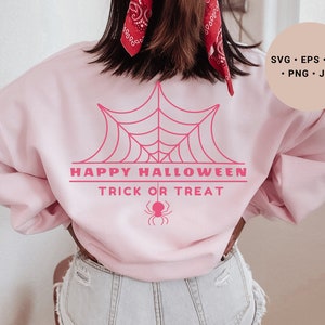 K&ouml;nnte beinhalten: Rosafarbener Pullover mit einem pinkfarbenen Spinnennetz-Motiv und dem Text "Happy Halloween Trick or Treat".