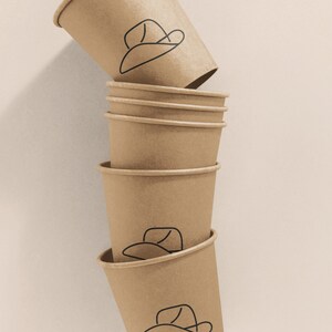 May include: A stack of six brown paper cups with a simple line drawing of a cowboy hat on each cup.