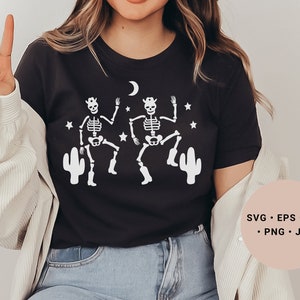 May include: A black t-shirt with a white design of two skeletons wearing cowboy hats and dancing. The skeletons are surrounded by stars and cacti. The text "SVG - EPS - DXF - PNG - JPG" is in the lower right corner of the image.