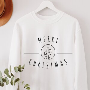 May include: White sweatshirt with black text that reads "Merry Christmas" with a cactus graphic in a circle.