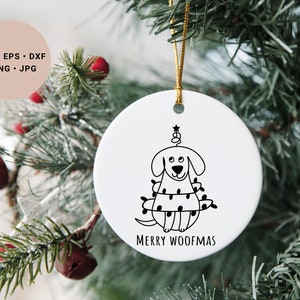 May include: White ceramic Christmas ornament with a black line drawing of a dog wearing Christmas lights and a star on top of its head. The text "Merry Woofmas" is printed below the dog.
