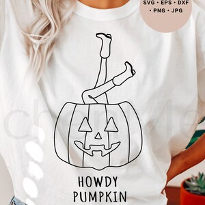 May include: White t-shirt with a black line drawing of a pumpkin with legs sticking out of the top. The text "Howdy Pumpkin" is below the pumpkin.