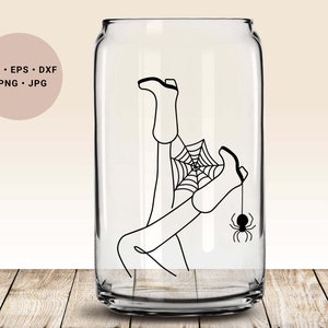 May include: A black and white line drawing of a person's legs and feet trapped in a spider web with a spider hanging from the foot. The image is inside a clear glass can.
