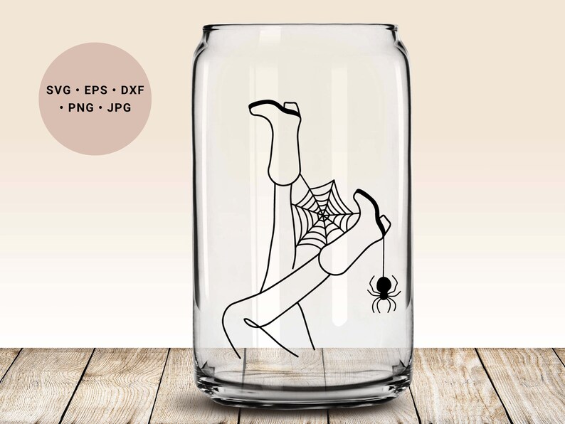 May include: A black and white line drawing of a person's legs and feet trapped in a spider web with a spider hanging from the foot. The image is inside a clear glass can.