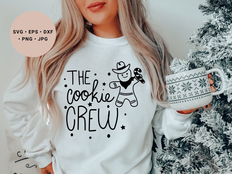 May include: White sweatshirt with black text that reads "THE cookie CREW" and a gingerbread man graphic.