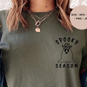 May include: A green t-shirt with a black graphic of a ghost wearing a cowboy hat and the text "Spooky Season".