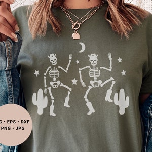 May include: A green t-shirt with a white design of two skeletons wearing cowboy hats and boots, dancing in front of cacti and stars. The text "SVG - EPS - DXF - PNG - JPG" is on a white circle in the lower left corner of the image.