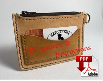 May include: A brown leather wallet with a zipper closure and a pocket for cards. The wallet has a stitched edge and a small loop on the side. The text "PDF pattern & Instructions" is superimposed on the image.