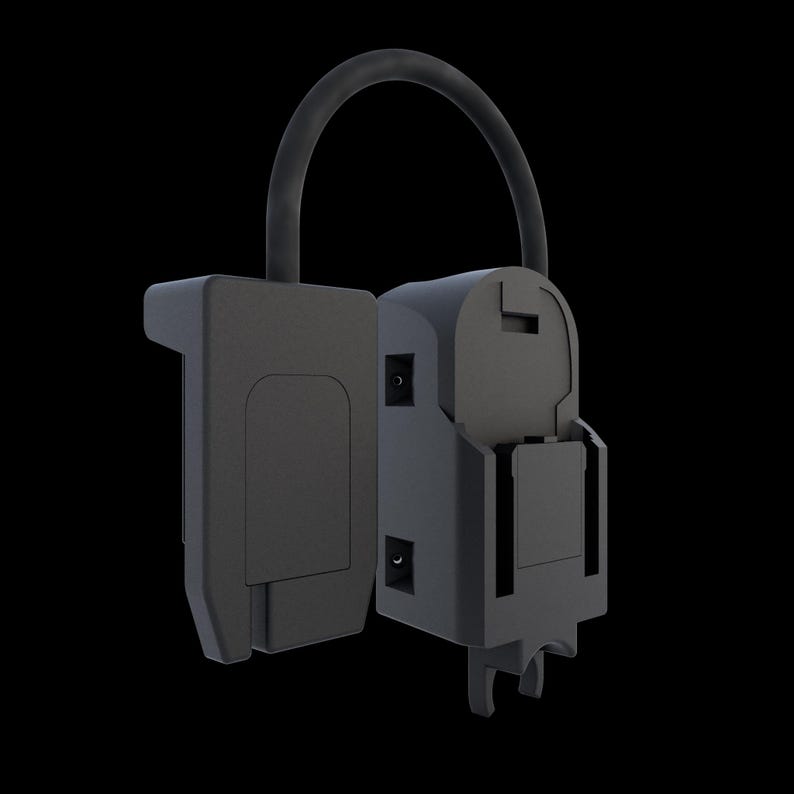 May include: A dark gray, open, electrical device with a curved handle. The device has a rectangular shape with a hinged compartment and several small circular openings. The background is black.