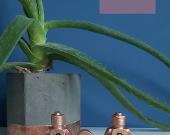 May include: A set of three ceramic mugs with a speckled, matte finish. Each mug features a different color: light blue, cream, and gray. The mugs have a simple, modern design, perfect for coffee or tea.