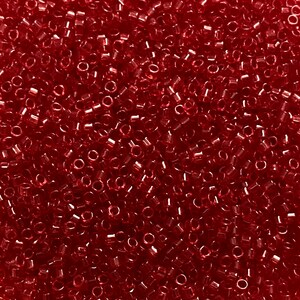May include: A close-up of a mass of small, translucent, red glass beads. The beads are cylindrical with a hole through the middle. They are scattered randomly. The beads have a glossy finish and reflect light, creating a shimmering effect.