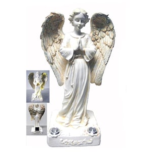 May include: White angel statue with wings outstretched, praying with hands clasped. The statue has a distressed finish and is illuminated by two solar powered lights.