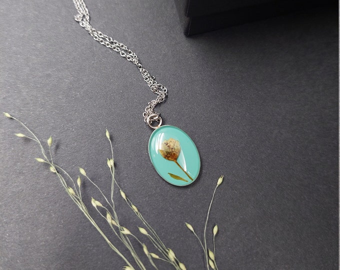 Tiny medallion with dried flowers.