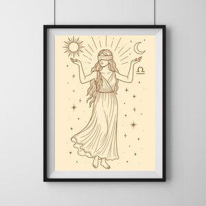 May include: Framed art print featuring a line drawing of a woman with a blindfold, holding a sun and moon. The artwork is in shades of brown and beige, with stars and the text "STELLAR PRITNZ CO."