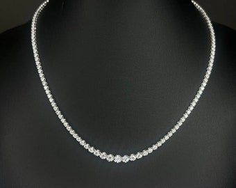 May include: A delicate silver necklace with a row of small, sparkling diamonds.