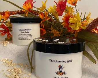 May include: A white jar of body butter with a black lid and a goat logo. The jar is labeled "The Charming Goat Body Butter 10 oz/296 ml".