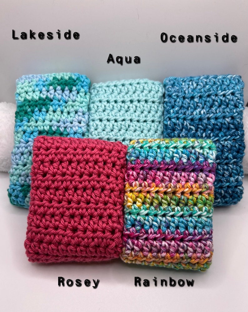 May include: Five crocheted dishcloths in different colors and patterns. The dishcloths are labeled "Lakeside", "Aqua", "Oceanside", "Rosey", and "Rainbow".