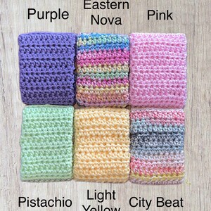 May include: Nine crocheted squares in different colors, including purple, pink, light yellow, pistachio, and a multi-colored square called "Eastern Nova". The squares are arranged in a 3x3 grid.