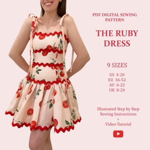 May include: A light pink dress with a red tomato pattern and scalloped red trim. The dress has tie straps and a flared skirt. Text on the image reads "THE RUBY DRESS" and "PDF DIGITAL SEWING PATTERN". The image also includes size information.