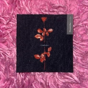 May include: A black patch with a red rose design and the word "Depeche Mode" printed on the right side.