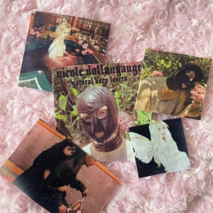 May include: A collection of four vintage-style stickers featuring various images. One sticker shows a person wearing a black mask, another shows a person wearing a black leather mask, another shows a person in a pool, and the last sticker shows a white butterfly.