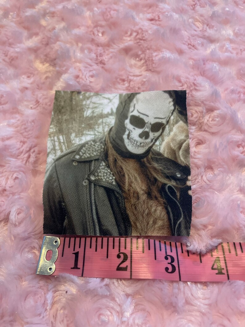 May include: A black and white skull mask with a leather jacket. The image is in a vintage style with a sepia tone.