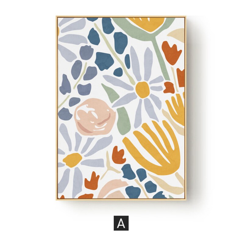 May include: Floral art print in a gold frame. The artwork features a colorful, abstract floral design with daisies, leaves, and other stylized flowers in shades of blue, orange, yellow, and pink on a white background. The letter "A" is in the bottom corner.