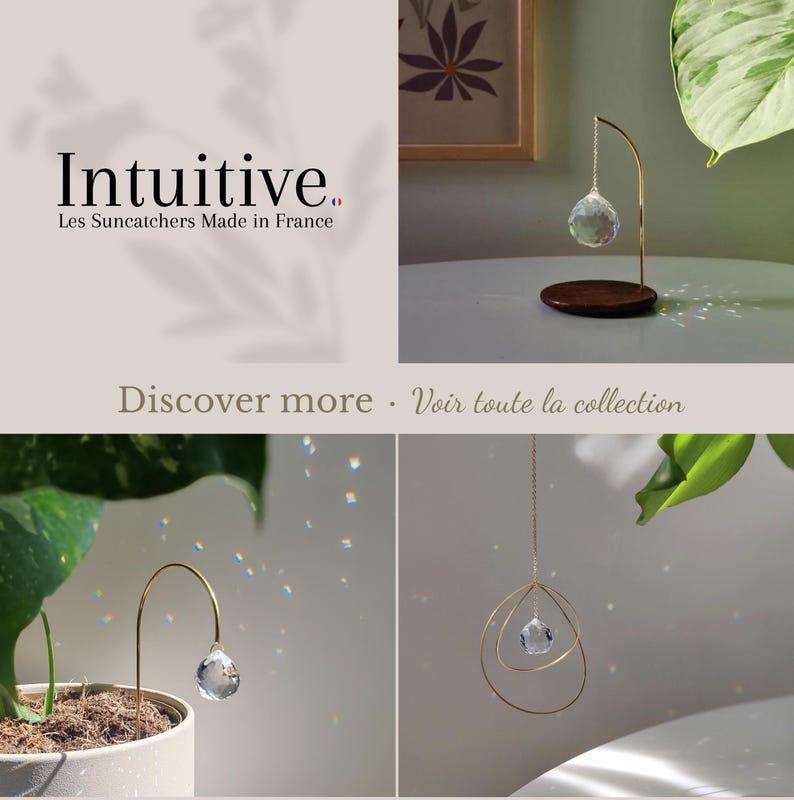 May include: A collection of suncatchers featuring clear faceted crystal prisms suspended from gold-toned metal stands and hoops. One design includes a dark wood circular base. Text reads: Intuitive. Les Suncatchers Made in France. Discover more.