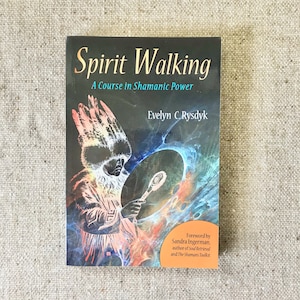 May include: A book titled "Spirit Walking: A Course in Shamanic Power" by Evelyn C. Rysdyk. The cover features an illustration of a person in ceremonial attire holding a drum, with colorful, swirling energy effects. The book has a foreword by Sandra Ingerman.