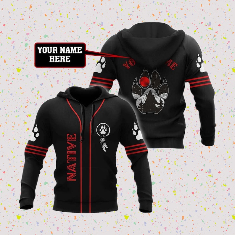 May include: Black hooded sweatshirt with red stripes and a white paw print design on the back. The front of the sweatshirt has the word "NATIVE" printed vertically down the left side and a white dreamcatcher design on the right side. The text "YOUR NAME HERE" is in a speech bubble.