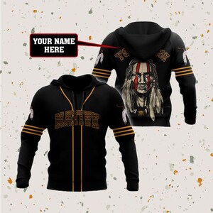 May include: Black baseball jersey with a Native American design and the word "NATIVE" in gold lettering. The back of the jersey features a Native American man with a headdress and the text "YOUR NAME HERE".