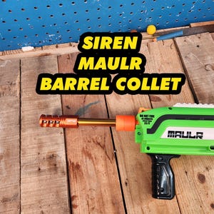 May include: A green and black toy blaster with a gold barrel and orange accents. The text "SIREN MAULR BARREL COLLET" is displayed on the image. The blaster has a black handle and the text "MAULR" is visible.