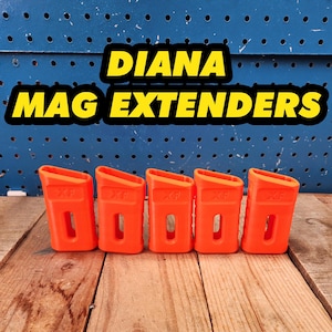May include: Five orange plastic magazine extenders for a Diana air rifle. The extenders are labeled "XP".