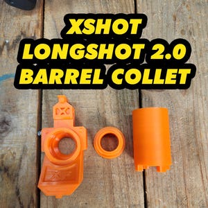 May include: Three orange plastic components for an XSHOT LONGSHOT 2.0 BARREL COLLET. The set includes a main housing piece with an XF logo, a small circular ring, and a cylindrical sleeve, all featuring a matte finish and structural details.
