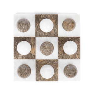 May include: A marble checkerboard game with white and brown marble pieces. The board is made of white marble with brown marble squares.