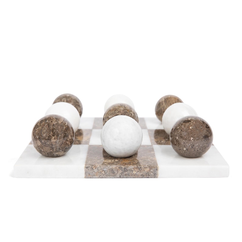 May include: A marble game set with a white and brown checkerboard and white and brown marble balls.