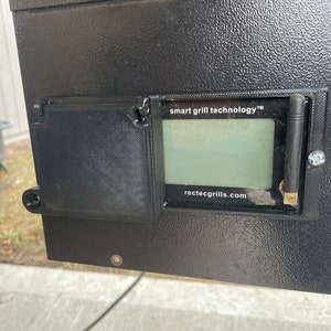 May include: Close-up of a black grill with a digital display that reads "smart grill technology" and "rectecgrills.com".