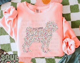 May include: A pink sweatshirt with a floral pug silhouette design. The design says "Pug Mom" in black text.