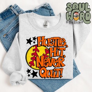 May include: A gray sweatshirt with a softball graphic and the text "Hustle Hit Never Quit!" in orange and red lettering.